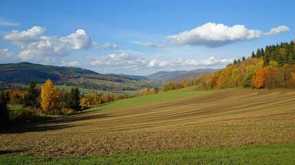 Vibrant autumn landscape with rolling hills and a clear blue sky in the countryside