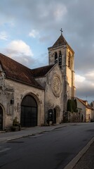 Fototapeta premium Charming stone church at dusk in a quaint village showcasing historical architecture