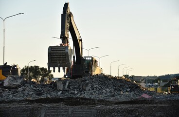 demolition of the bridge with construction equipment