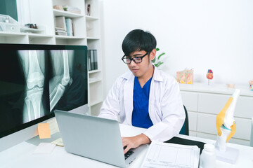 Doctor dress lap coat patient's surgical data in orthopedic clinic. specializes in diagnosing and treating conditions related to bones and joints, provides consultations on physical therapy.