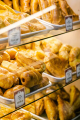 A display case filled with a variety of freshly baked pastries highlights indulgence and the allure of French bakeries