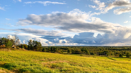 Scenic rural landscape with lush green fields and dramatic clouds, ideal for concepts of tranquility and nature appreciation