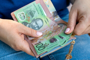 woman counting new 50 100 AUD Australian Dollars financial concept