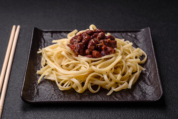 Rice noodles with beans, meat, tomato sauce, spices and herbs