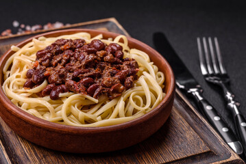 Rice noodles with beans, meat, tomato sauce, spices and herbs