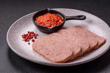 Delicious canned pink spiced ham or spam with salt, spices and herbs