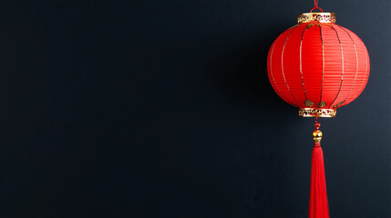 Obraz premium Beautiful Red Lantern Hanging Against a Dark Background Symbolizing Festivity and Celebration