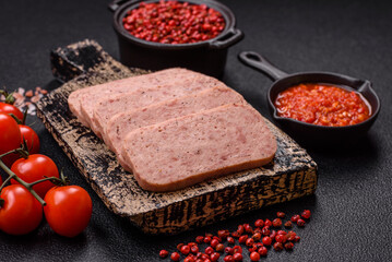 Delicious canned pink spiced ham or spam with salt, spices and herbs