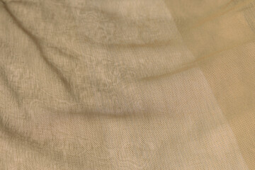 beige curtain smooth wavy surface narrow focus textured pastel color artistic background textile material