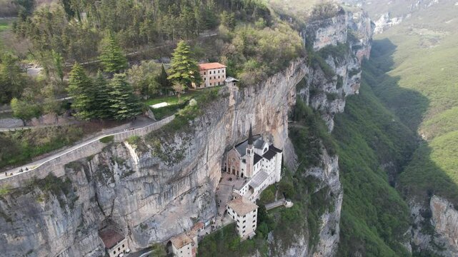Drone flight over Santuario de la Madonna della Corona in Garda lake, Italy. Panoramic view