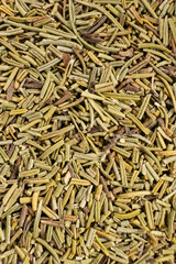 Background macro dried rosemary leaves top view, seasoning texture.