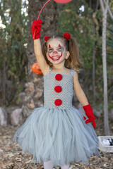 Little girl dressed up for Halloween in the woods