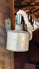 Old metal kerosene lantern attached to a wooden frame
