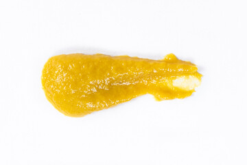 Smear of mustard sauce on white background isolate, creativity in cooking, macro texture