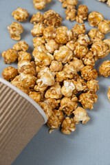 Sweet caramelized popcorn spilled out of the glass.