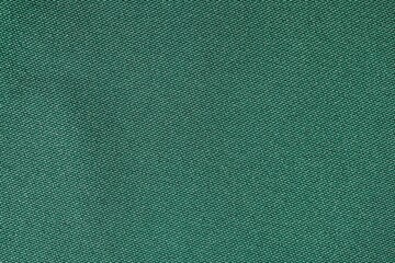High-quality texture of rich royal green fabric with a soft and luxurious feel. This deep green material features a smooth, perfect for backgrounds, textiles, wallpapers