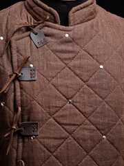 Historical fashion. Medieval knight cloth. Padded jacket gambeson.