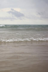 Sea view with small waves in cloudy weather. Balearic Sea, Salou, Spain. View of the waves on the sea from a lower angle. Landscape with sea and clouds