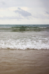 Sea view with small waves in cloudy weather. Balearic Sea, Salou, Spain. View of the waves on the sea from a lower angle. Landscape with sea and clouds