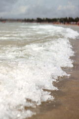Sea view with small waves in cloudy weather. Balearic Sea, Salou, Spain. View of the waves on the sea from a lower angle. Landscape with sea and clouds