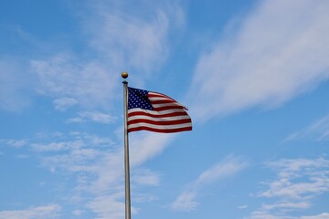 Obraz premium The United States flag waving in the breeze.