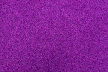 A vibrant purple surface features a rich texture that draws attention, setting the perfect backdrop for creative projects or design work in any artistic environment