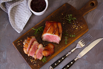 Roast duck breast fillets with rosemary and thyme. View from above