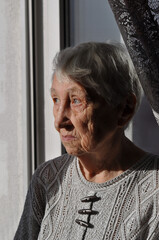 Head shot close up portrait thoughtful middle aged retired woman worrying about personal health problems. Upset older female retiree thinking of family troubles, feeling lonely, sitting at home.