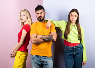 Group of friends posing in studio. Group of tree People. Friends face. Three young people portrait. Great team. Group of three cheerful young people in casual wear looking at camera.