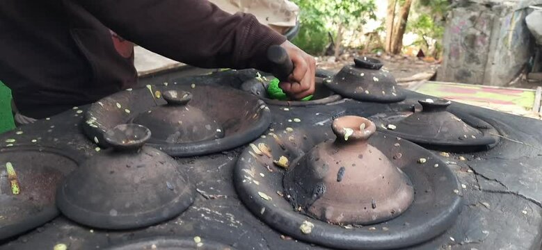 Serabi pandan seller using a clay pan for cooking at food street. Serabi is a traditional pancake from Indonesia