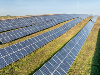 Rows of Photovoltaic Panels. Compose Renewable Energy. Drone Point of View. Solar Power Station Panels. Fields Green Energy at Sunset. Electrical Power Ecology environment. Electrical Innovation