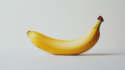 A solitary banana is showcased against a white backdrop.