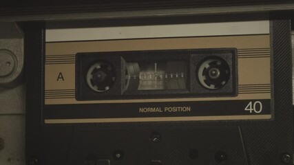 Cassette tape player rolling, close up shot. A vintage music template video, with a natural color aesthetic