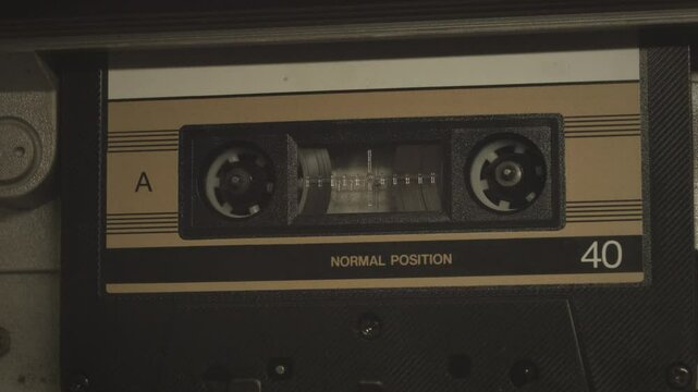 Cassette tape player rolling, close up shot. A vintage music template video, with a natural color aesthetic