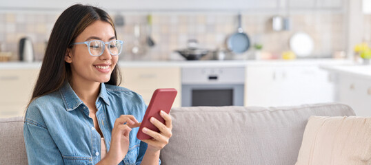 Young asian woman using mobile phone for chatting in social media network, buying goods on...