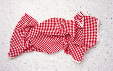 Folded red kitchen towel on a white background