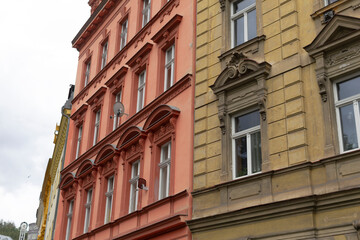 A colorful row of buildings, each featuring distinct styles and variations of windows that add character to the skyline