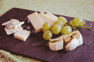 A Table of cheese slices is the perfect end to a typical meal, a gorgeous aperitif or a very rich snack.
