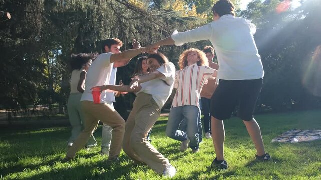 Friends enjoying a fun game of limbo in an outdoor park setting