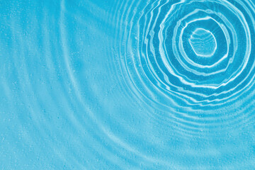 drops on water with circles on a blue background