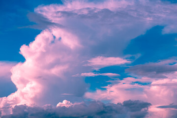 Magic pink fabulous cumulus clouds on blue sky at sunrise sunset nature background wallpaper