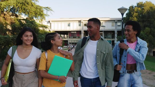 Front view of small group of diverse young American student friends hanging out while leaving university campus after educational classes. Diversity and education lifestyle concept.