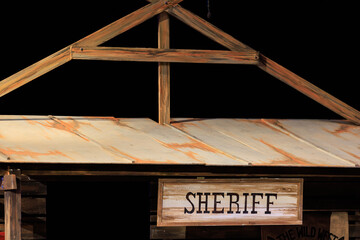 A sign that says Sheriff is on a building