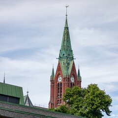 Clock tower of red brick Johanneskirken church in Bergen, Norway