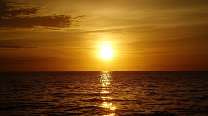 Fototapeta premium Golden sunset casting reflections over calm ocean waters at dusk