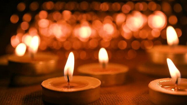 All Saints' Day greeting banner with bokeh effect. All Hallows' Day. Solemnity of All Saints. Candles with fire on shiny background