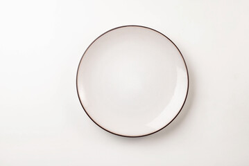 A clean, white plate with a brown rim. Perfect for food photography, tableware,