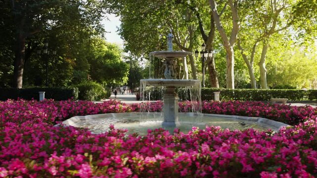 Beautiful fountain with blooming flowers in El Retiro Park, Madrid, sightseeing in Madrid, capital of Spain