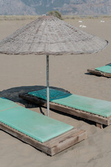 turquoise sun beds with sun umbrella on the beach