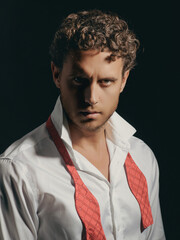 Serious man with unshaven face in shirt and untied bow closeup. Portrait of the handsome man. A Hipster guy model headshot. Male face. Young handsome man. Confident male model. Man looking proud.